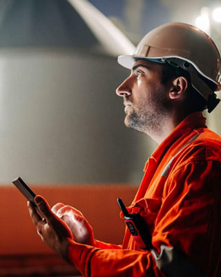 SDS	Resources_SDS_Mobile4x5.jpg	Industrial worker wearing a hard hat and orange safety uniform using a smartphone at a manufacturing facility during nighttime operations.	Not Started																							