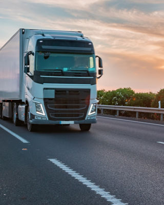 Truck with refrigerated semi-trailer moving on the highway