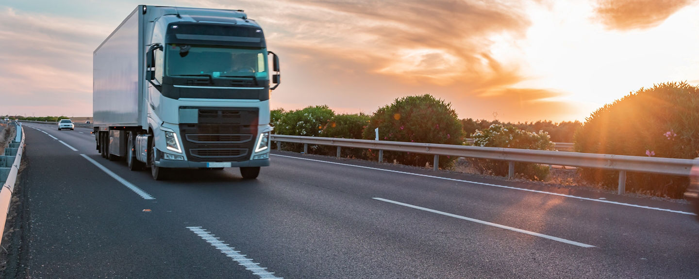 Truck with refrigerated semi-trailer moving on the highway