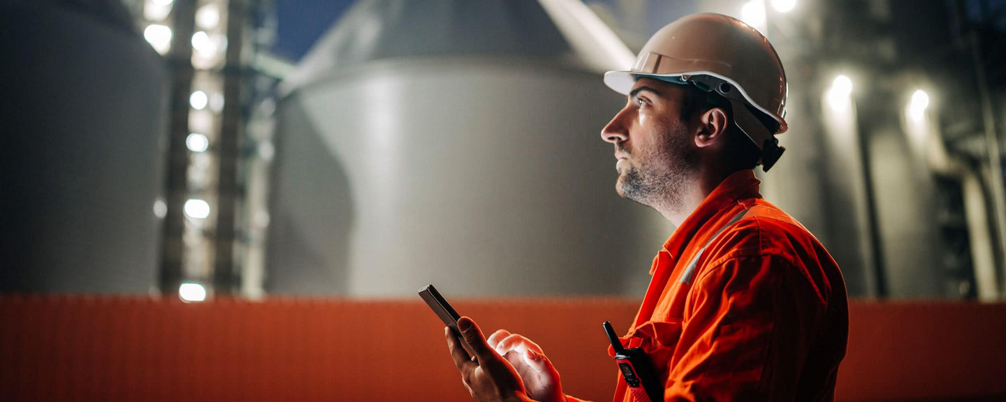 SDS	Resources_SDS_Mobile4x5.jpg	Industrial worker wearing a hard hat and orange safety uniform using a smartphone at a manufacturing facility during nighttime operations.	Not Started																							